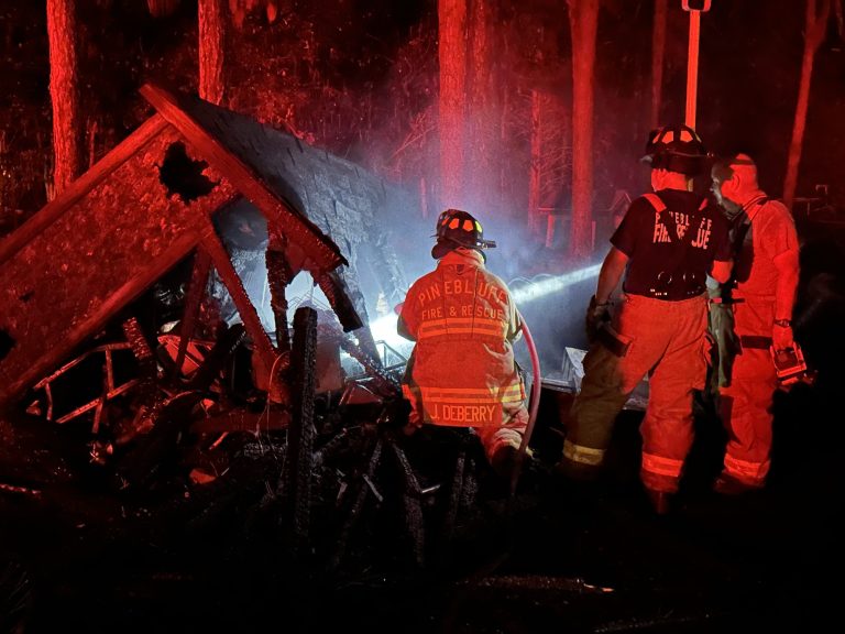 Outdoor fire spreads to multiple vehicles, storage building