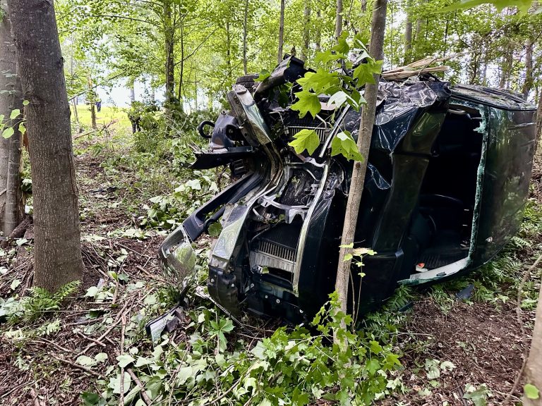 Driver runs stop sign, travels 100 yards into woods, overturns