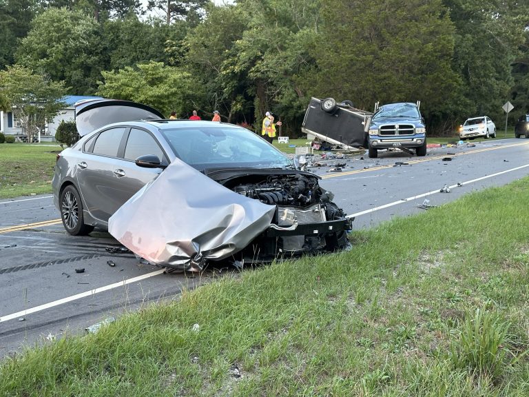 Pickup truck towing trailer overturns, shuts down highway for 2 hours