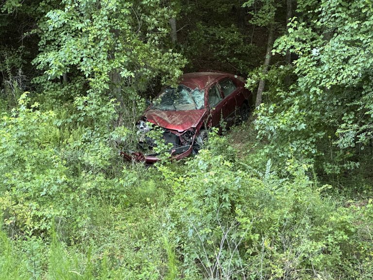 Car rolls after going down steep embankment, driver injured