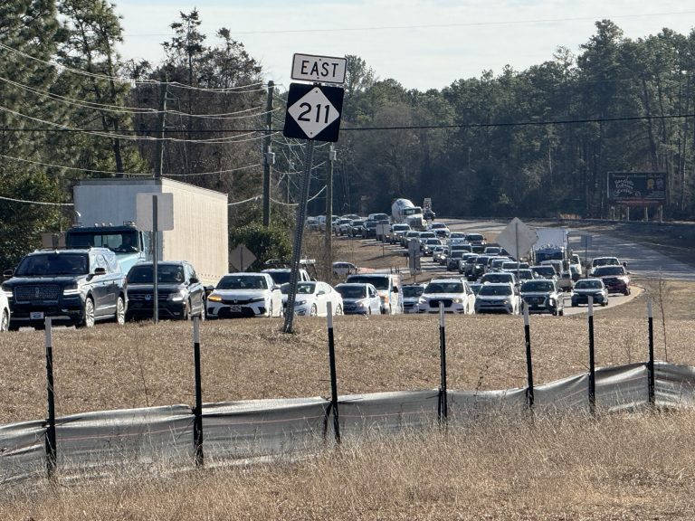 Semi-truck brings down lines and power pole onto Highway 211