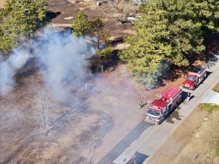 Flames from fire pit spread to 2 buildings in Cameron