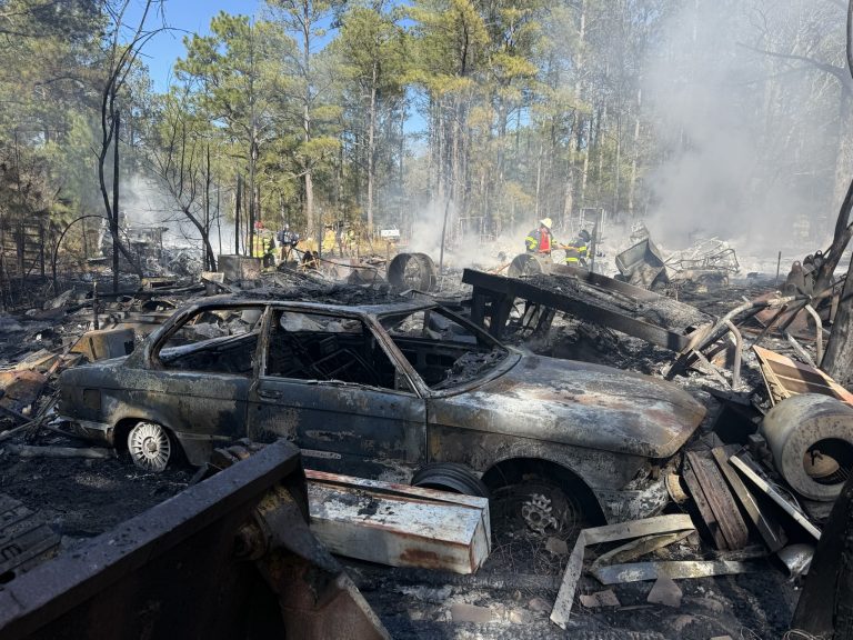 Large outside fire destroys several vehicles and building