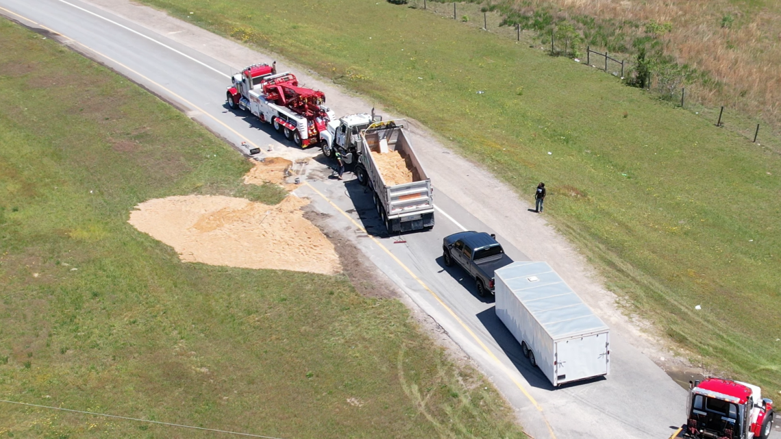 Semi-truck overturns on ramp to U.S. Highway 1, spills load of sand ...