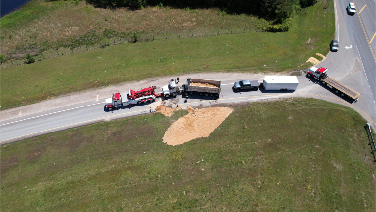 Semi-truck overturns on ramp to U.S. Highway 1, spills load of sand