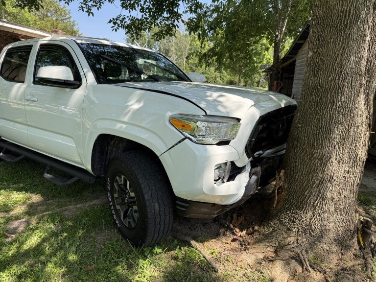 Driver transported to hospital after striking car in yard