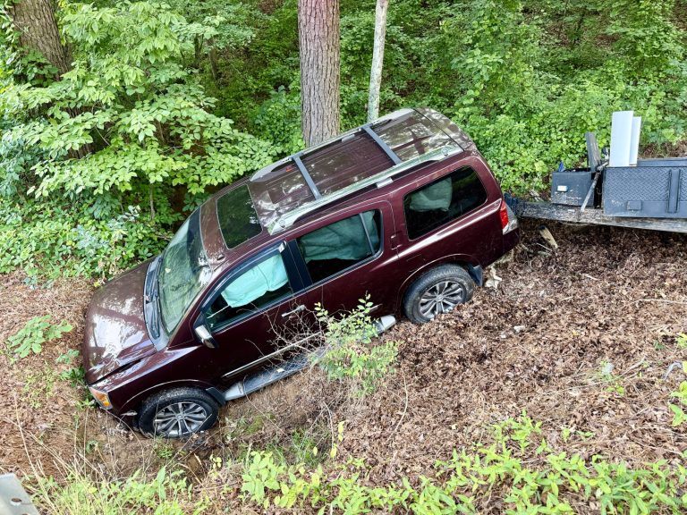 SUV crashes down embankment, lands in creek bed