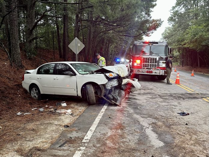Emergency crews block a lane of Highway 211 after crash.